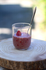 Banana and berry nice cream, served in a garden. Selective focus.
