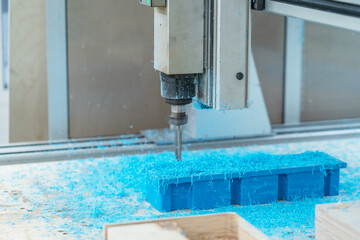 CNC drill machine cutting mold from plastic, close up.