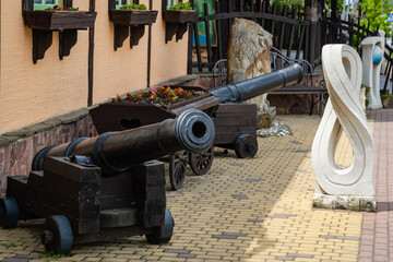 Ancient cannons on  sidewalk under windows of Museum of Bread and Wine in Arkhipo-Osipovka....