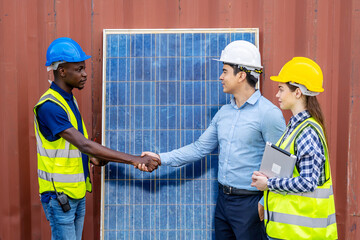 Foreman shaking hand to a Businessman and his woman colleague team in front of solar panels . Solar panels in the field, business deal between client and foreman.