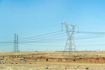 High voltage transmission towers in desert of egypt
