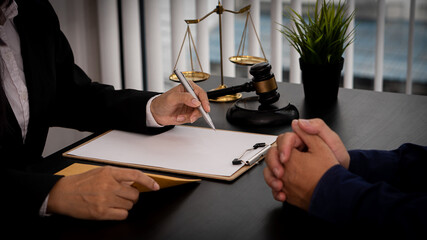 Lawyer Consulting Businessman in Office with Judge Hammer and Justice Scales with Laptop, Attorney...