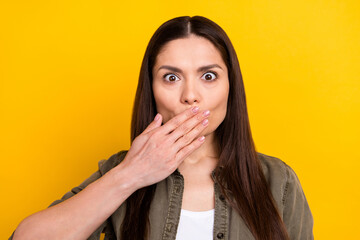 Photo of shocked charming mature lady dressed green clothes arm cover lips isolated yellow color background