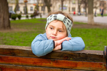 child sitting on a bench