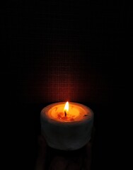 A glowing candle in the dark