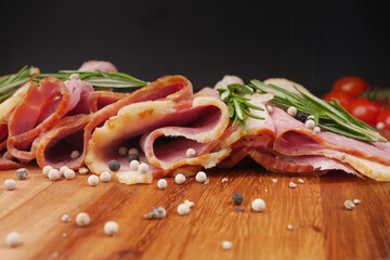 Raw fed bacon strips on chopping board .