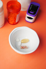 Close up of medical pills and capsules in a small container 