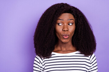 Portrait of attractive cheerful girl looking aside guessing copy space pout lips isolated over violet purple color background