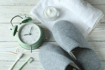 Sleep routine accessories on white wooden background