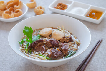 Noodle soup with braised pork and pork balls in bowl, Thai food style