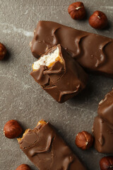 Candy bars and nuts on gray textured table