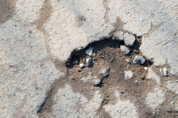 close-up - a terrible pothole on the road, an obstacle to traffic