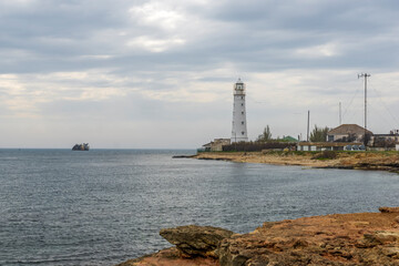 Fototapeta na wymiar Lighthouse by the sea.