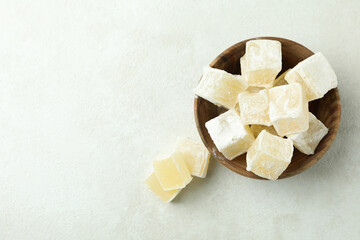 Bowl with turkish delight cubes on white textured background
