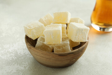 Tea and delicious turkish delight on white textured background