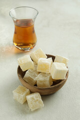 Tea and delicious turkish delight on white textured background