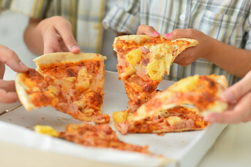 Portrait of happy family eating pizza together