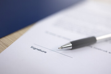 Close up pen is placed on top of the document with a space left for the signature.