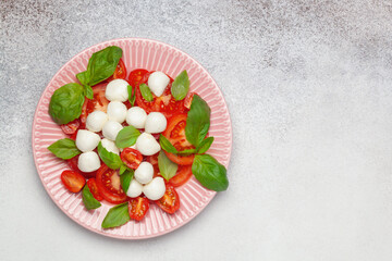 Italian caprese salad with tomatoes, mozzarella cheese and basil leaves. Top View.