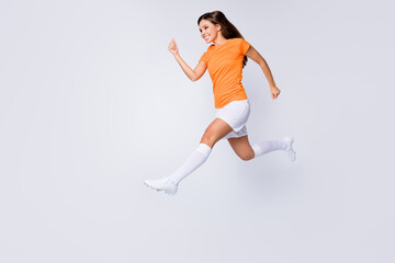 Full body profile photo of excited lady player soccer jump high running speed score goal wear...