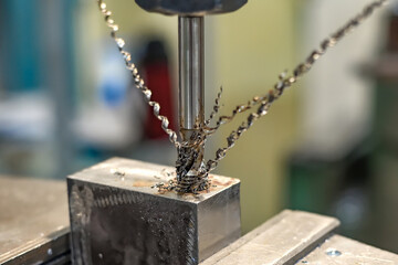 A tap on a machine for tapping a hole in a part.