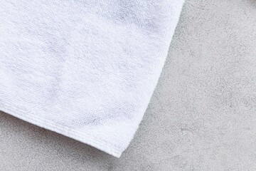 Clean white towels folded on a white wood table.