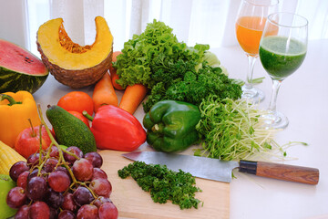 Assorted fresh ripe fruits and vegetables on the table at white curtain background,