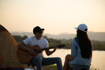 Asian couple holding alcohol beer bottle for cheer and drink