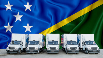 Solomon Islands flag in the background. Five new white trucks are parked in the parking lot. Truck,...