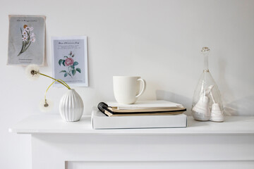 A seventies-style fluted vase with two fluffy dandelions is on the dresser.