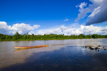 Bergendal, Suriname - August 2019: Passengers In Wooden Traditional Boat Sailing Along River.