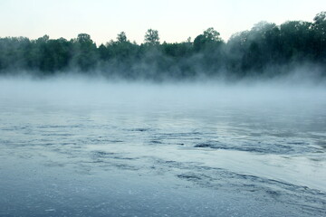 Fog on the river early in the morning during the summer