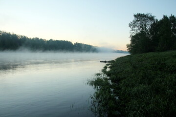 Fototapeta na wymiar Fog on the river early in the morning during the summer