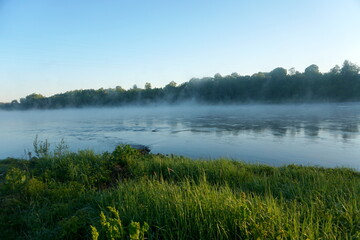 Fototapeta na wymiar Fog on the river early in the morning during the summer