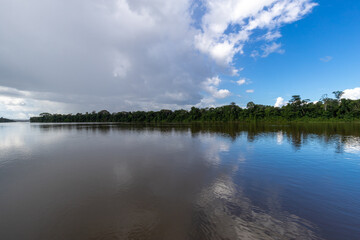 Naklejka na ściany i meble Overcast Weather With White Clouds Reflecting On Suriname River