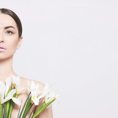 Portrait of a beautiful woman with a bouquet of flowers