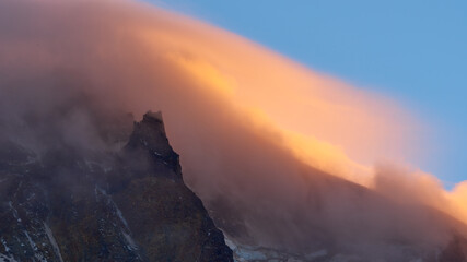 Scenic colorful clouds on the slopes of Mount Hood at sunset. Evening view from Cooper Spur.