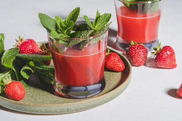 Fresh strawberry juice, cold summer juicy fruits cocktail with mint, hard light