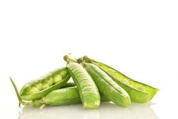 Several organic green pea pods, close-up, isolated on white.