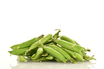 Several organic green pea pods, close-up, isolated on white.