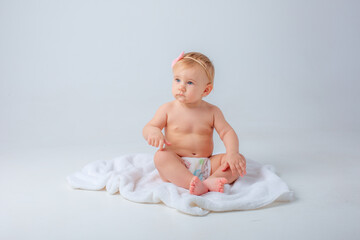 baby sitting on a towel isolated on a white background