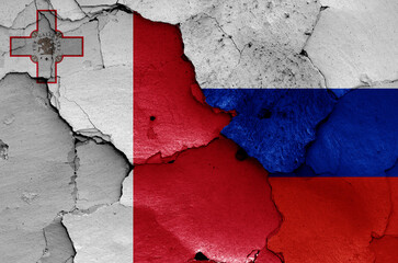 flags of Malta and Russia painted on cracked wall