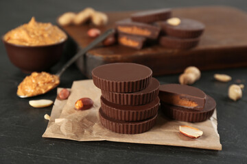 Delicious peanut butter cups on black table