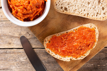 Sliced toast bread with sobrasada on rustic wooden table. Typical Mallorca food in Spain.	
