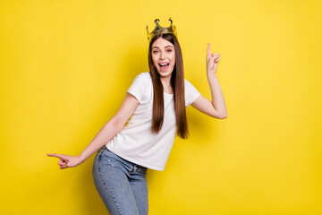 Portrait of attractive trendy cheerful girl wearing crown dancing having fun isolated over bright...