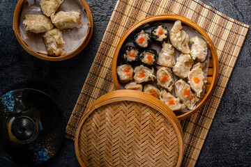 Assorted Chinese Dimsum in bamboo basket. Dimsum is a large range of small dishes that Cantonese people traditionally enjoy in restaurants for breakfast and lunch.