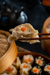 Assorted Chinese Dimsum in bamboo basket. Dimsum is a large range of small dishes that Cantonese people traditionally enjoy in restaurants for breakfast and lunch.