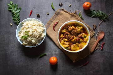 Kadhi chawal an Indian delicacy prepared with rice by putting fried fritters in yogurt based curry.