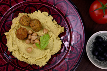 Chickpea hummus with falafel top view stock images. Traditional homemade hummus on a plate still life stock images. Delicious Middle Eastern cuisine photo