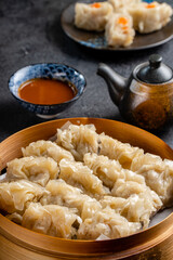 Assorted Chinese Dimsum in bamboo basket. Dimsum is a large range of small dishes that Cantonese people traditionally enjoy in restaurants for breakfast and lunch.
